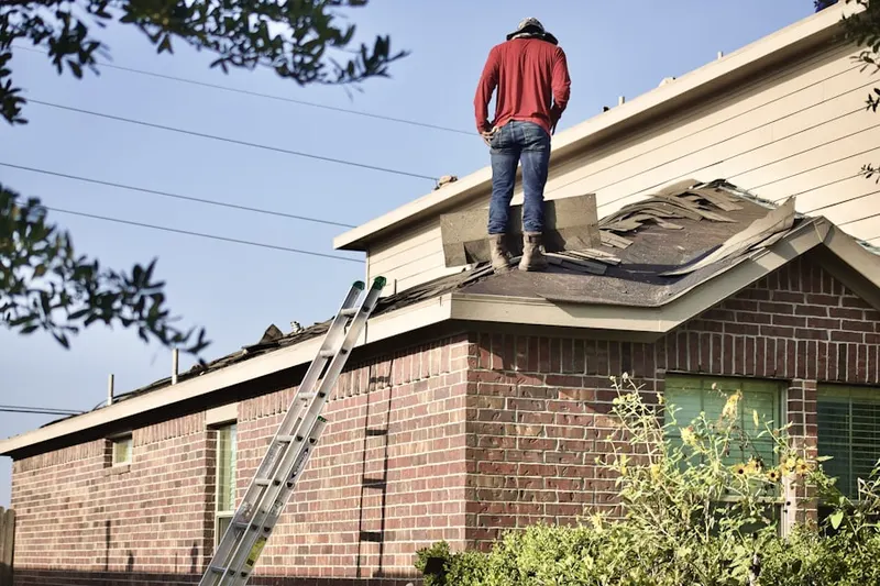 Professional roofer working on a residential roof in Riva